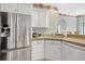 Well lit kitchen with stainless steel appliances, white cabinetry, and a sink at 75 Haig Ct., Georgetown, SC 29440