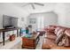 Cozy living room with vaulted ceiling, ceiling fan, leather seating, and a large screen television at 75 Haig Ct., Georgetown, SC 29440