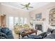 Inviting living room with a fireplace, ceiling fan and direct access to the outdoor living space at 75 Haig Ct., Georgetown, SC 29440