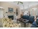 Spacious living room featuring plush seating, a fireplace, built-in shelving and access to other rooms at 75 Haig Ct., Georgetown, SC 29440