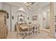 Bright dining room with chandelier, arched entryways and rustic furniture at 7538 Ventura Ct., Myrtle Beach, SC 29572