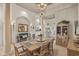 Open dining area with columns and rustic furniture and an adjoined living space at 7538 Ventura Ct., Myrtle Beach, SC 29572