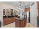 Well-equipped kitchen with stainless steel refrigerator, granite counters, and wooden cabinets at 7538 Ventura Ct., Myrtle Beach, SC 29572