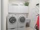 Bright laundry room features a washer, dryer, utility sink, and ample storage cabinets at 7538 Ventura Ct., Myrtle Beach, SC 29572