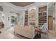 Bright living room with built-in shelving, a fireplace, and views of the backyard pool at 7538 Ventura Ct., Myrtle Beach, SC 29572