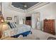 The main bedroom has a trey ceiling, fan, neutral colors and access to other rooms at 7538 Ventura Ct., Myrtle Beach, SC 29572
