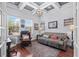 This bright office features hardwood floors, a trey ceiling, and a large sofa at 7538 Ventura Ct., Myrtle Beach, SC 29572