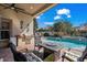 This outdoor living area features a grill, seating, and view of the gorgeous pool at 7538 Ventura Ct., Myrtle Beach, SC 29572