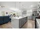 Open kitchen with gray cabinets, white countertops, a large island, and stainless steel appliances at 781 Flowering Branch Ave., Little River, SC 29566