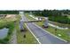 Aerial view of a neighborhood entrance with a stone sign amidst landscaping, showcasing a welcoming community at 8072 Bear Claw Way, Conway, SC 29526
