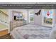 Cozy bedroom with a light purple quilt, dresser with TV, and a view of the inlet at 885 S Waccamaw Dr., Garden City Beach, SC 29576