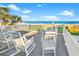 Relax on this deck with white rocking chairs and enjoy stunning views of the beach and ocean beyond at 885 S Waccamaw Dr., Garden City Beach, SC 29576