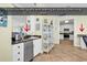 Kitchen area with an undermount stainless steel sink and granite countertops and an open view to living area at 885 S Waccamaw Dr., Garden City Beach, SC 29576