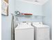 Functional laundry room with washer, dryer, and storage shelving at 885 S Waccamaw Dr., Garden City Beach, SC 29576