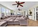 Spacious living room with a large sectional sofa, tile flooring, and views into the kitchen and dining areas at 885 S Waccamaw Dr., Garden City Beach, SC 29576