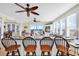 Living room featuring ocean views, ceiling fans, and bar seating at kitchen island, perfect for coastal living at 885 S Waccamaw Dr., Garden City Beach, SC 29576