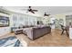 Open-concept living room with a large sectional sofa, tile flooring, and views into the kitchen and dining areas at 885 S Waccamaw Dr., Garden City Beach, SC 29576