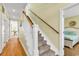 Hallway staircase with carpet steps and wooden handrail leads to the upper level and bedrooms at 885 S Waccamaw Dr., Garden City Beach, SC 29576