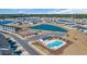 Expansive aerial view of a planned community with a sparkling pool, amenity center, and scenic pond at 892 Harrison Mill St., Myrtle Beach, SC 29579