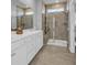 This is a well-lit bathroom with a double vanity and a walk-in shower with glass door at 892 Harrison Mill St., Myrtle Beach, SC 29579