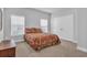 Cozy bedroom with two windows, a closet, and a comfortable-looking floral bed at 892 Harrison Mill St., Myrtle Beach, SC 29579