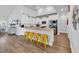 Bright kitchen features white cabinets, granite counters, stainless steel appliances, and island with seating at 892 Harrison Mill St., Myrtle Beach, SC 29579