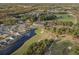 Aerial view of golf course community with beautiful greens, sand traps, pond, and homes at 9035 Binnicker Dr., Murrells Inlet, SC 29576