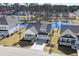 Aerial view of the home, showcasing its manicured lawn and the nearby community pond at 9035 Binnicker Dr., Murrells Inlet, SC 29576