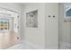 Modern bathroom featuring a large glass shower, gold hardware, and lake views at 9035 Binnicker Dr., Murrells Inlet, SC 29576