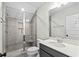 Updated bathroom with glass shower, gray vanity, and contemporary finishes at 9035 Binnicker Dr., Murrells Inlet, SC 29576