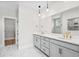Bright bathroom featuring double vanity, gold hardware, marble tile flooring, and a walk-in closet at 9035 Binnicker Dr., Murrells Inlet, SC 29576
