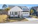 Beautiful white home with a inviting front porch, lush lawn, and two car garage at 9035 Binnicker Dr., Murrells Inlet, SC 29576