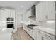 Modern kitchen with white cabinets, stainless steel appliances, and quartz countertops at 9035 Binnicker Dr., Murrells Inlet, SC 29576