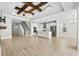 Spacious living room with hardwood floors and a decorative tray ceiling, leading to the kitchen at 9035 Binnicker Dr., Murrells Inlet, SC 29576
