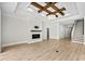 Bright living room featuring a fireplace, tray ceilings, and hardwood floors at 9035 Binnicker Dr., Murrells Inlet, SC 29576