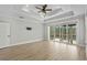 Large main bedroom with a tray ceiling and access to a screened in porch through sliding glass doors at 9035 Binnicker Dr., Murrells Inlet, SC 29576