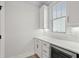 Walk-in pantry with white cabinetry, quartz countertop, a wine cooler, and a window at 9035 Binnicker Dr., Murrells Inlet, SC 29576