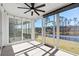 Screened-in porch featuring a ceiling fan, string lights, and a view of the backyard and pond at 9035 Binnicker Dr., Murrells Inlet, SC 29576