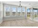 Bright sun room with three large windows, transom window, and glass doors to a screened porch at 9035 Binnicker Dr., Murrells Inlet, SC 29576