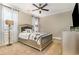 Cozy bedroom with a ceiling fan, carpeted floor, and a comfortable bed at 9800 Plumfield Ct., Myrtle Beach, SC 29579