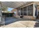View of covered patio with concrete floors and screened in porch attached to a brick home at 9800 Plumfield Ct., Myrtle Beach, SC 29579