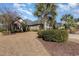 A landscaped front yard with a beautiful brick home and mature trees at 9800 Plumfield Ct., Myrtle Beach, SC 29579