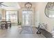 Inviting foyer with decorative glass front door, wood floors, and elegant light fixture at 9800 Plumfield Ct., Myrtle Beach, SC 29579