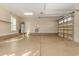 View of an empty two car garage with sealed floors, windows, and automatic door at 9800 Plumfield Ct., Myrtle Beach, SC 29579