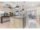 Spacious open kitchen with island seating, stainless appliances, and access to the dining area at 9800 Plumfield Ct., Myrtle Beach, SC 29579