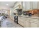 Well-appointed kitchen with stainless steel appliances, granite countertops, and warm cabinetry at 9800 Plumfield Ct., Myrtle Beach, SC 29579