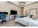 Elegant main bedroom boasts tray ceilings, an electric fireplace, seating area, and ensuite access at 9800 Plumfield Ct., Myrtle Beach, SC 29579
