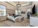 Elegant main bedroom boasts tray ceilings, a seating area, and a modern chandelier at 9800 Plumfield Ct., Myrtle Beach, SC 29579