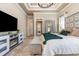 Elegant main bedroom boasts tray ceilings, an electric fireplace, seating area, and ensuite access at 9800 Plumfield Ct., Myrtle Beach, SC 29579