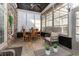 Cozy sun room with brick and shiplap accents, tile floor, and ceiling fan at 9800 Plumfield Ct., Myrtle Beach, SC 29579